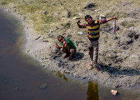 Two boys play in the river outside of the Tomb of I'timad-ud-Daulah