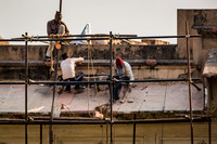 Three men working on repairs of The Pearl Mosque