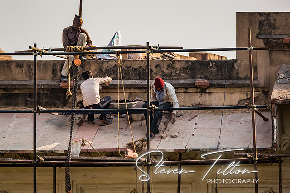 Three men working on repairs of The Pearl Mosque