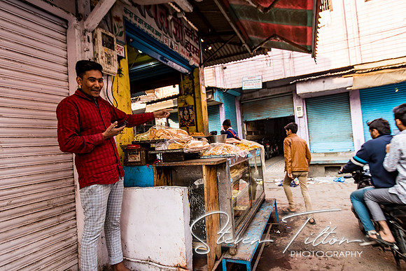 Local merchant asking me to take a photo of his friend
